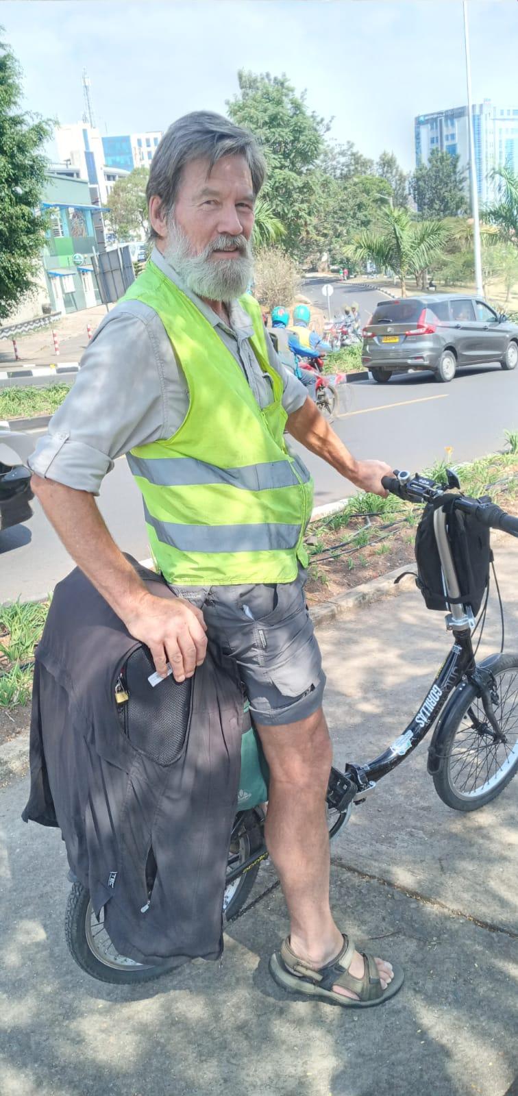 A person wearing a safety vest and shorts

Description automatically generated